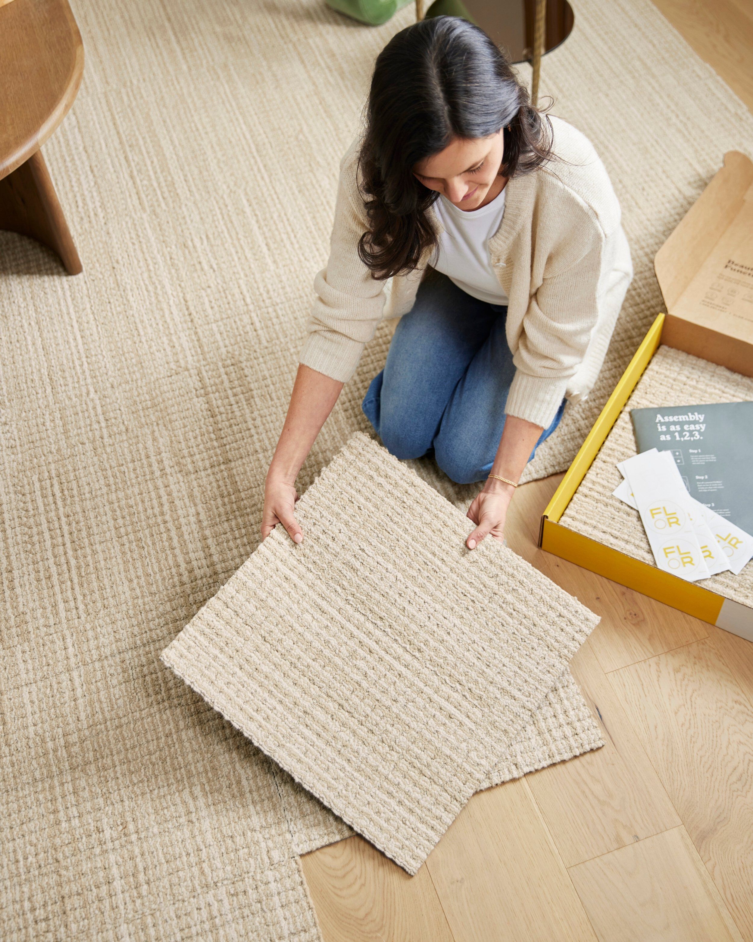 FLOR area rug being installed tile by tile